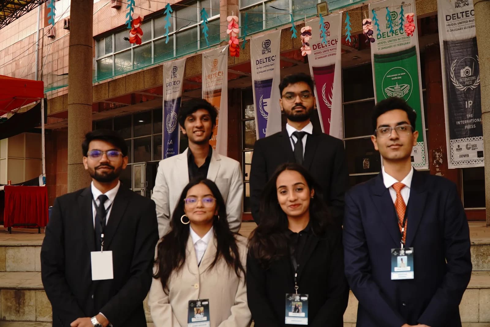 The secretariat standing outside the venue beneath the conference banners