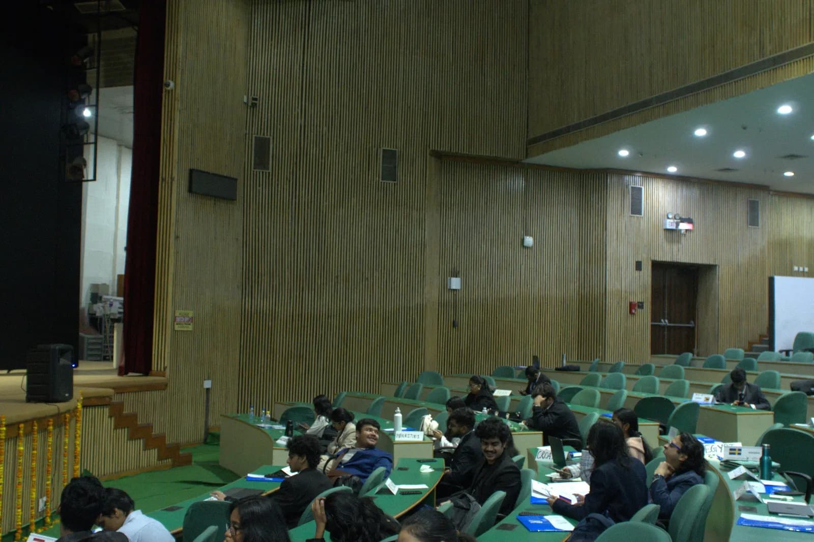 Delegates working at the green benches of the assembly hall