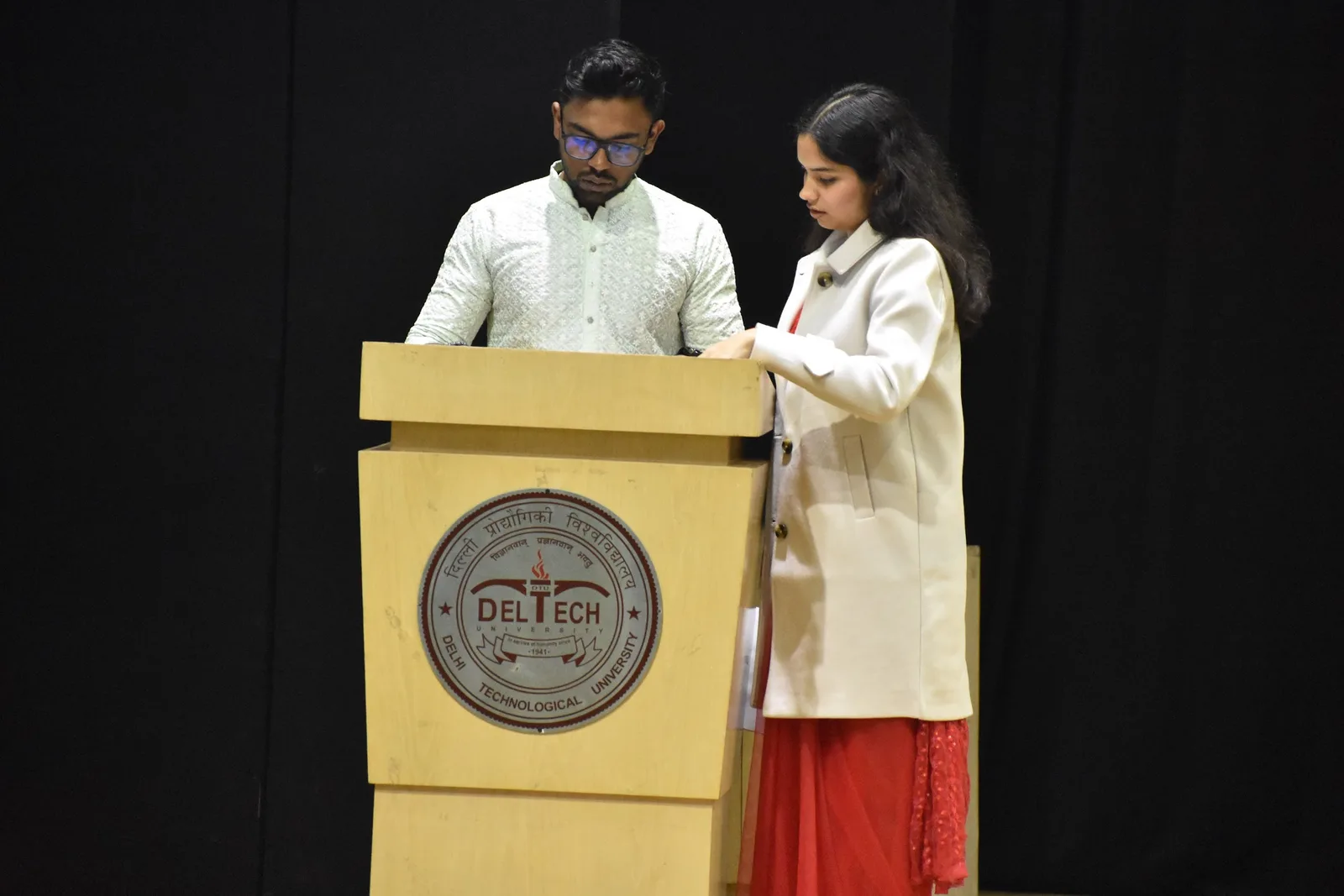 Two students speaking from the university rostrum
